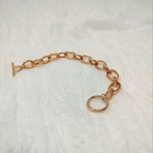 Gold tone oval chain link toggle bracelet